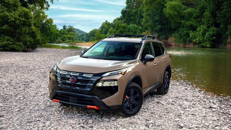 2025 Nissan Rogue in brown by a body of water.